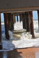 Waves crashing against the pier after hurricane Mathew