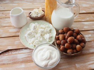 Ingredients for baking - milk eggs cheese nuts flour wheat, wood background
