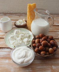 Ingredients for baking - milk eggs cheese nuts flour wheat, wood background