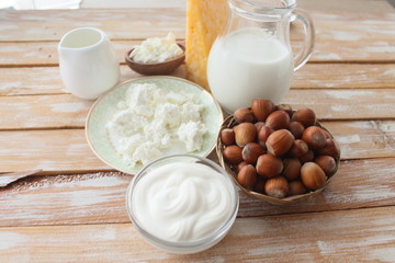 Ingredients for baking - milk eggs cheese nuts flour wheat, wood background
