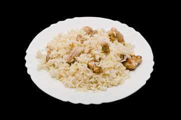 Pilaf on plate - dish of asian cuisine. Isolated on black backgr