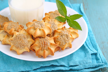 homemade cookies with halva on a white plate. Blue background