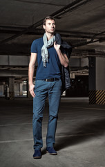 Fashion shot: handsome young man in underground parking