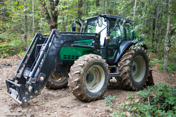 Obraz premium New modern agricultural tractor isolated in the woods