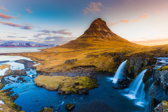 Kirkjufell Volcano Mountain with waterfalls in late winter, Iceland winter seson natural landscape