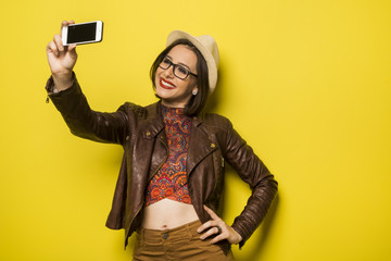 Portrait of a Beautiful successful smiling girl doing selfie  on