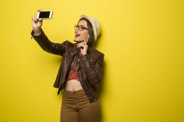 Portrait of a Beautiful successful smiling girl doing selfie  on