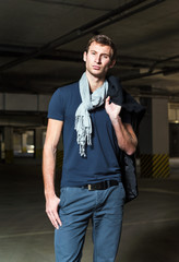 Fashion shot: handsome young man wearing coat and jeans