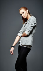 Studio fashion shot: beautiful young girl in leggings and jacket