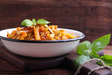 ragout of zucchini and tomato with garlic and basil, in a white plate, selective focus