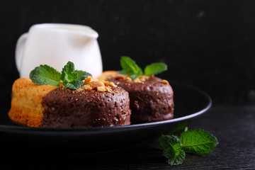 sponge cake in a black plate decorated with mint