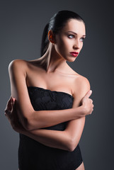 Fototapeta premium Studio fashion shot: gorgeous young girl wearing black body