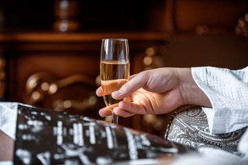 Men's hand holding wine glass at festive event