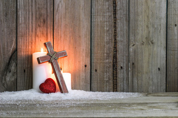 White candles, wood cross and red heart