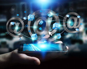 Businessman holding 3D rendering email icon over mobile phone