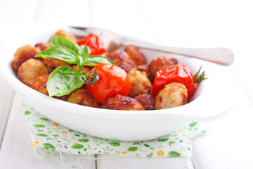 Meatballs with tomato in a white dish on a white background. selective focus.