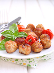 Meatballs with tomato in a white dish on a white background. selective focus.