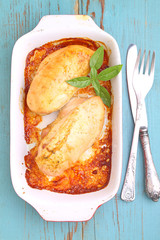 Baked breast of chicken in the white dish