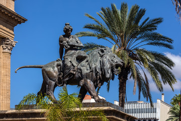 Naklejka premium 19th century bronze statue representing the Lyric seated on a lion by Sir Mario Rutelli, located next to the Massimo Theater's entrance staircase in Palermo, Sicily.