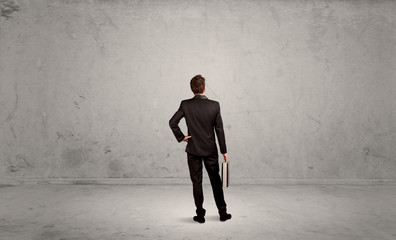 Businessman lost in empty urban space