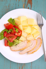 
baked potatoes with meat and tomato salad