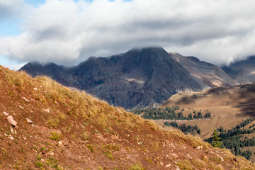 Fototapeta premium Peak covered with a low hanging cloud in the autumn