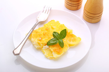 Potato gratin with cheese on a white plate