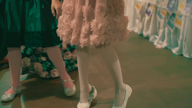 Two little girls with air  balloons dancing 