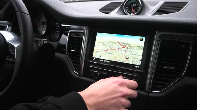 man uses a gps navigator in the car.