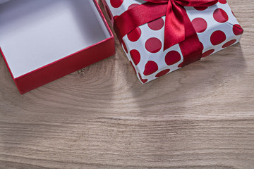 Red opened gift box on wooden board horizontal version celebrati