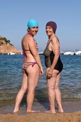 two happy women on the beach