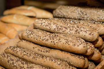 wholemeal bread baguettes in a basket to shop in a supermarket