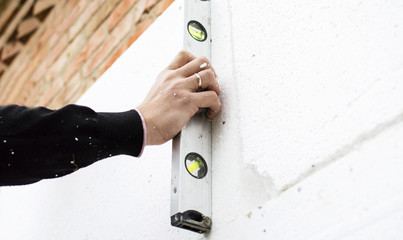 Check flatness of the wall using a level