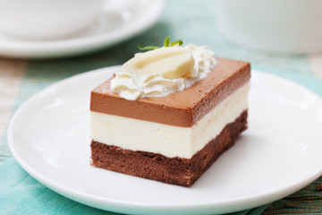Three chocolate mousse cake on a white plate