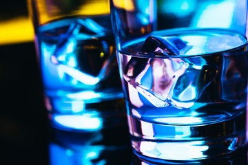 Two glasses of vodka with ice closeup