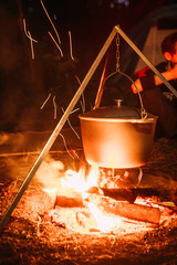 boiling pot over an open fire on a blurred background