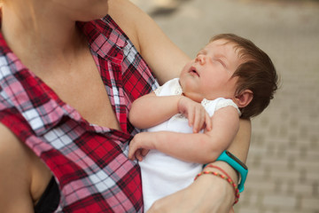 Woman holding sleeping baby 