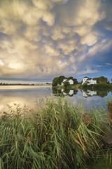 Fototapeta na wymiar Beautiful mammatus clouds formation over lake landscape immediat
