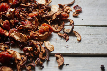 Set of dried fruits of apples, apricots and raisins lying on a wooden table closeup