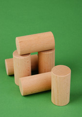 wooden geometric shapes on a green background
