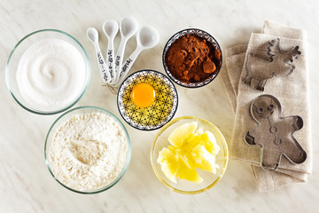 Ingredients for baking on a white marble table : flour, eggs, co