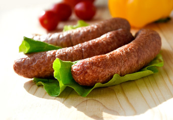 sausage and vegetables served on a wooden board for copy space