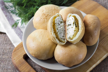 Pies with salty cottage cheese and greens