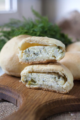 Pies with salty cottage cheese and greens