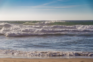 Breaking ocean waves at Praia da Adraga beach in Portugal