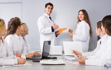 Health-care workers and head physician at colloquium in clinic