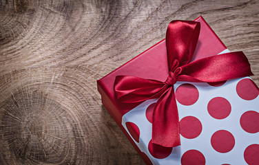 Red packed gift box on wooden board celebrations concept