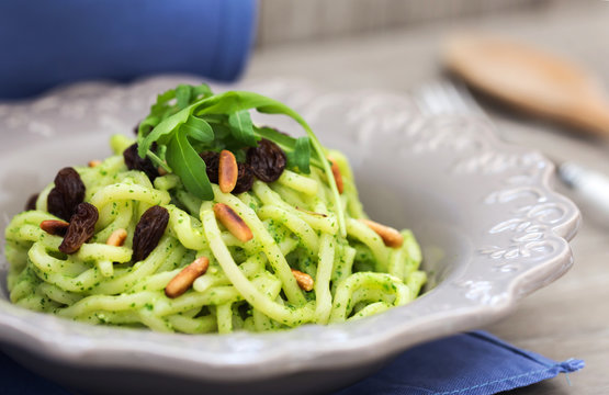 recipe of troccoli with rocket pesto, roasted pine seed and raisins