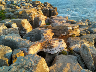 Rocks in sunset light near Cabo Carvoeiro, Peniche, Portugal