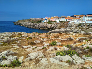 Fototapeta na wymiar View to the bay with rocks and houses in Peniche, Portugal